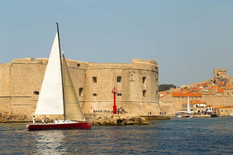 Dubrovnik: Romantic Sunset Sailing Adventure - Old Town views from the sea, walls and red roofs at golden hour